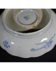 Blue and white porcelain bowl with hand painted designs and small square seal on bottom.