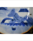 White porcelain plate with Misty Peaks and Arched Bridge design, abstract scene, scalloped rim, close-up view.