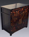 Black wood Chinese Chinoiserie cabinet with two drawers, gold floral accents, and scalloped hardware, front view.