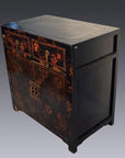 Black lacquered Chinese cabinet with gold detailing, scalloped hardware, and red patterned doors, front view.