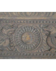 Brown wooden antique Indian carving with two mythical birds and lotus motif, bordered by intricate patterns, close-up.