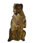 Brown hand-carved wood seated goat sculpture with necklace, 19th century Burmese, close-up view.