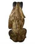 Brown wood seated goat sculpture with rustic finish and dark-tipped ears, hand-carved, 19th century Burmese style.