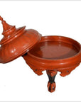 Close-up of antique Burmese red carved wood offering basket with pointed lid, three legs, 19th century.
