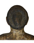 Brown wooden carving, back view, showing intricately braided hair and textured head and shoulders.