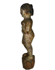 Weathered wood statue of nude child, side view, antique Burmese temple carving, arms at sides.