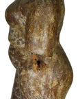 Weathered marble Burmese temple carving torso with broken arm and rounded belly, side view, on white background.
