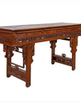 Dark wood Chinese altar console table with overhang top and carved open fretwork scroll detailing, studio view.