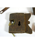 Close-up of antique Chinese and Indian metal locks with keyholes and string on a white surface.