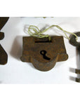 Close-up of antique metal Chinese and Indian locks with original keys displayed on a white surface.
