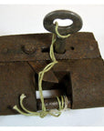 Close-up of antique metal Chinese and Indian locks with original keys and string on display.