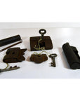 Brass and iron antique Chinese and Indian locks with original keys, some tied, displayed on a white surface.