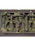 Brown wood carved Chinese temple plaque in frame, decorative wall art panel, close-up view.
