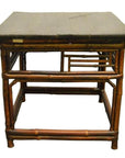 Dark lacquered bamboo side table with flat top and geometric rectangular designs on the sides.