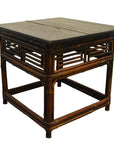 Brown lacquered bamboo side table with dark wood top and lattice-style bamboo sides, antique style.