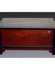 Black lacquer antique Chinese cabinet with dark brown top, legs, and reddish-brown front panel, on gray background.