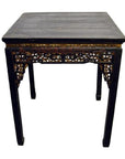 Black lacquer wood altar table close-up, antique Chinese style, showing carved details.