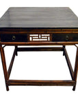 Black lacquered wood Chinese table with two drawers, bamboo-style legs, and central openwork panel, front view.