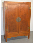 Tall brown lacquer antique Chinese cabinet with double doors, brass hardware, circular lock, and four legs.