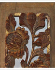Close-up of antique carved wooden panel with gold accents, floral and bird motifs, intricate detailing.