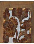 Close-up of antique carved wooden panel with gold accents, floral and bird motifs, intricate detailing.