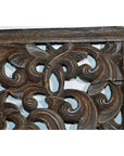 Close-up of brown teak floral lattice panel with antique Chinese carving, swirling patterns, and a right-side crack.