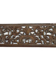 Brown teak floral lattice panel with intricate Chinese scrollwork carving, close-up.