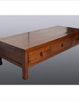 Brown tiger elm wood Chinese coffee table with three drawers, horse hoof legs, and metal ring handles.