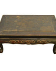 Dark wood Indonesian carved table with hand-carved details and curved lion's paw legs, front view.