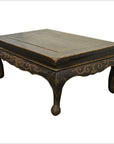 Dark wood Indonesian carved table with gold accents, hand-carved lion’s paw legs, antique style.