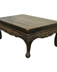 Dark wood Indonesian carved table with gold accents, hand-carved lion’s paw legs, antique style.