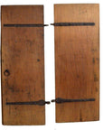 Natural wood antique Chinese doors with black metal hinges, round left-side handle, and aged patina, front view.