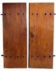 Close-up of brown wood antique Chinese doors with natural patina, visible wood grain, and black metal latch fittings.