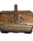 Brown wood box with ornate metalwork lock, distressed finish, vintage style.