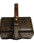 Rectangular dark wood Chinese dowry box with ornate metalwork and curved handle, top view.