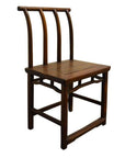 Dark wood Chinese elm chair with curved back and three vertical slats, antique handmade design, studio close-up.