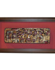 Close-up of antique Chinese gilt carving with hand-carved human figures and animals on a red background.