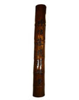 Brown bamboo column with vertical Chinese inscription, polished grain, and carved calligraphy, close-up view.