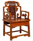 Natural wood antique Chinese chair with carved backrest and arms, hand-carved details visible, indoors.