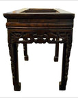 Dark wood hand-carved antique Chinese console or altar table with ornate legs and spandrels, front view.