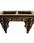 Brown wood Chinese hand-carved console table with carved legs, spandrels, and two rectangular openings, front view.