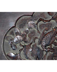 Dark rosewood lacquered Chinese wall plaque with hand-carved floral and bird design, close-up view.