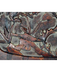 Close-up of dark rosewood lacquered wall plaque with hand-carved bamboo stems and leaves, antique Chinese design.