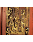 Red lacquer and gilt wood Chinese panel with three figures in traditional dress, textured background, close-up view.