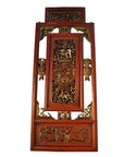 Red gilt wood Chinese carved panel with intricate relief depicting a courtyard scene, close-up view.