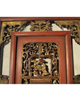Red and gold carved wood Chinese panel with courtyard scene, ornate floral patterns, and gilt relief details.