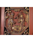 Red gilt wood Chinese carved panel, close-up of two figures in traditional dress, bordered by ornate decorative patterns.