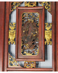 Gold-accented hand carved wood wall decor with two figures and intricate floral patterns.