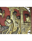 Red wooden panel with gold-painted hand-carved traditional Chinese figures engaged in daily activities.
