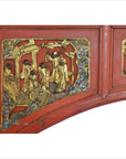 Red and gold wooden sign with hand-carved relief figures, blue and gold accents, antique style.